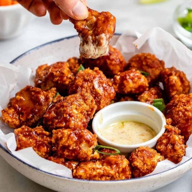 BUFFALO CAULIFLOWER WINGS AND FRIES.