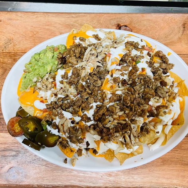 Los 3 Regios Mexican Restaurant's nachos with meat, cheese, sour cream, guacamole, and jalapeños.